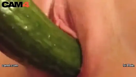 Webcam hottie Ivi Rein toys herself with a long cucumber