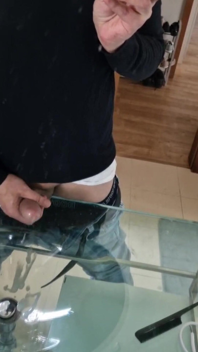 Hot guy jerks and cums shooting his load into the bathroom sink