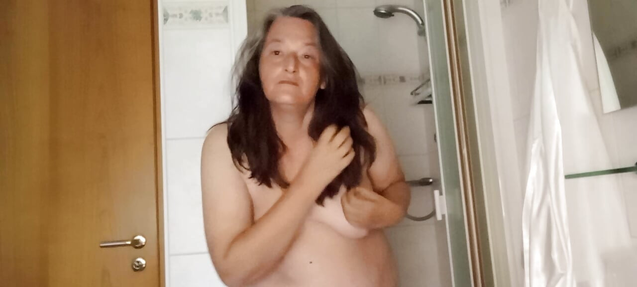 52-year-old chubby plays with her natural tits before showering - Will you come along?