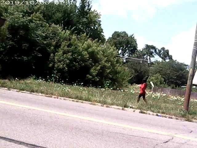 Detroit skinny black Street hooker in red tight mini dress.