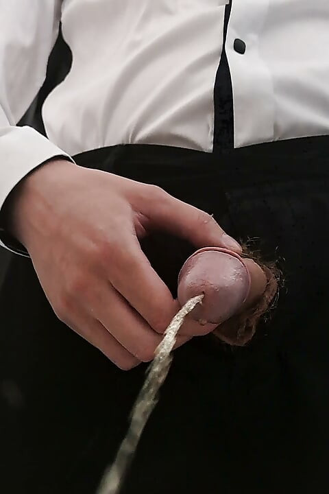 Man with a thick hairy cock pissing