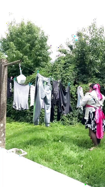 In gardening outfit to hang the laundry