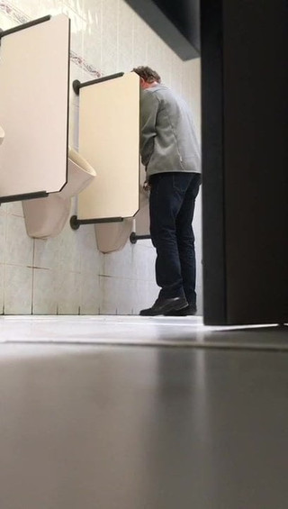 Older man peeing