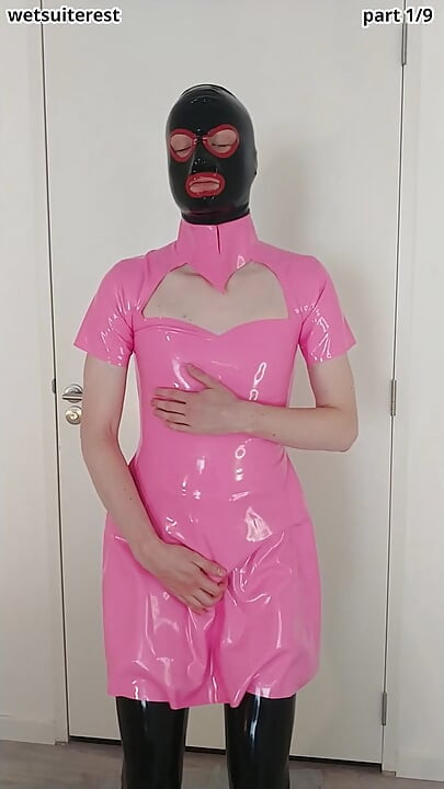 Putting on pink latex maid dress over rubber stockings and transparent pants