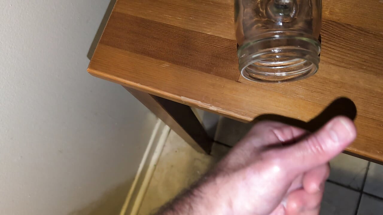 Fat man jerking his hard cock and cumming in a glass