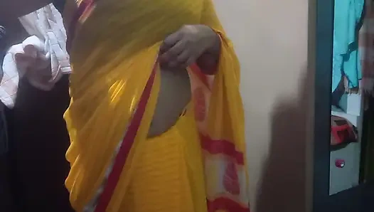 Indian housewife is wearing a yellow saree.