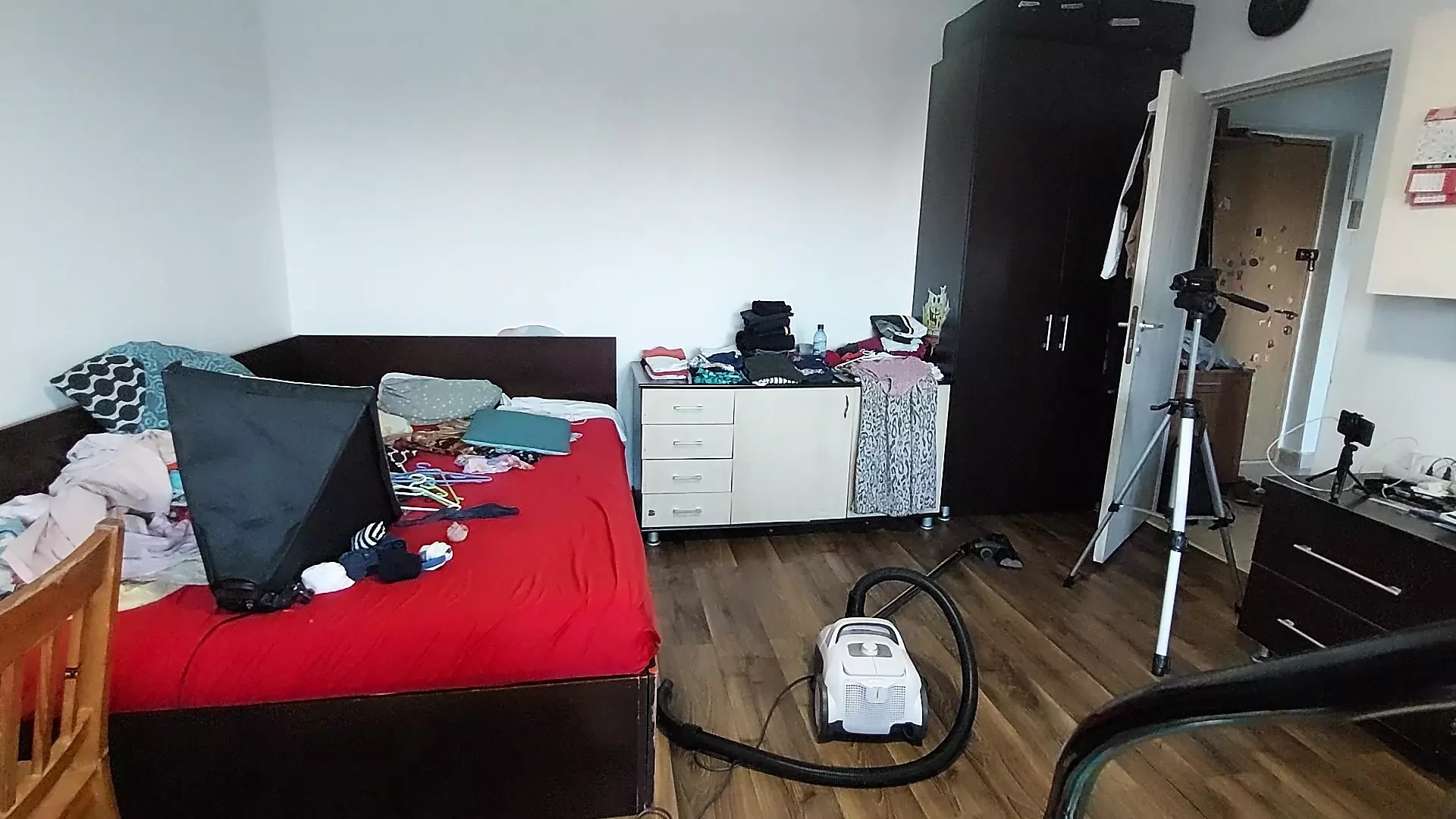 Sexy wife cleans with the vacuum cleaner in the bedroom. Sexy wife epilates the hair on her legs