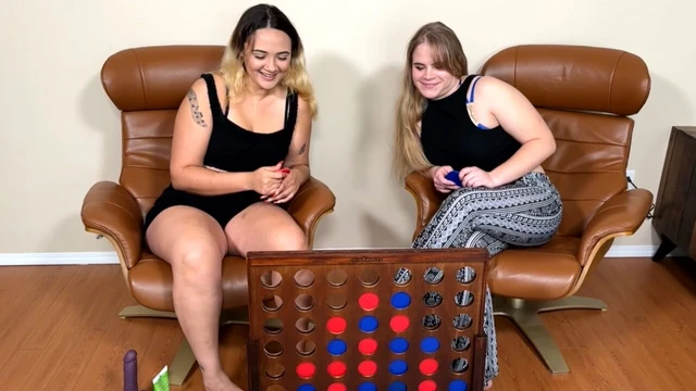 A large Connect 4 board is used for a lesbian strip game
