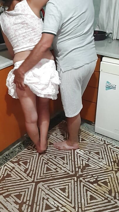 A Turkish couple flirting in the kitchen.