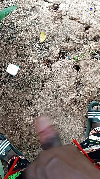 An African adult man masturbating inside the bush with his big dick