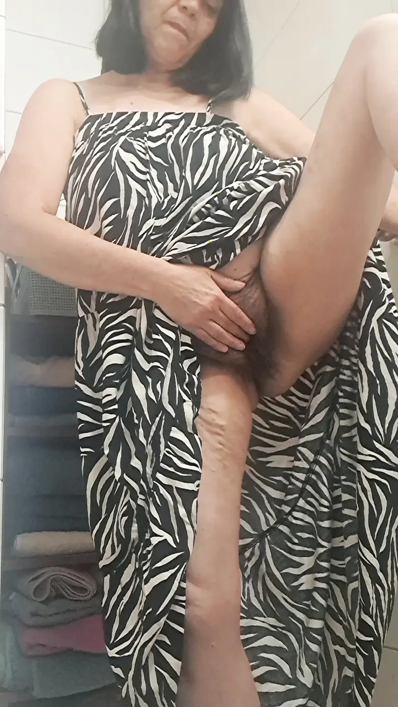 in the bathroom showing what’s under her dress to her young lover on camera