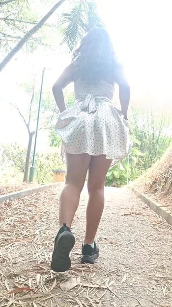 Colombian girl lifts her dress while walking