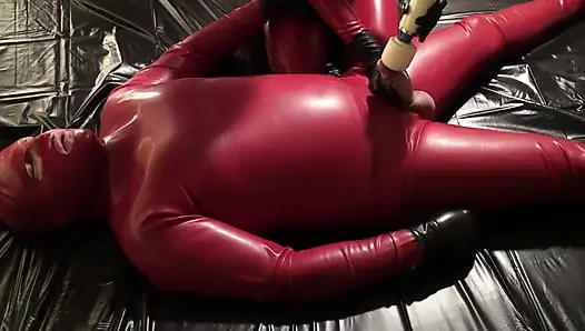 Latex Danielle in catsuit has latex masturbating games with her slave