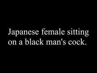 Japanese female sitting on a black man's cock.