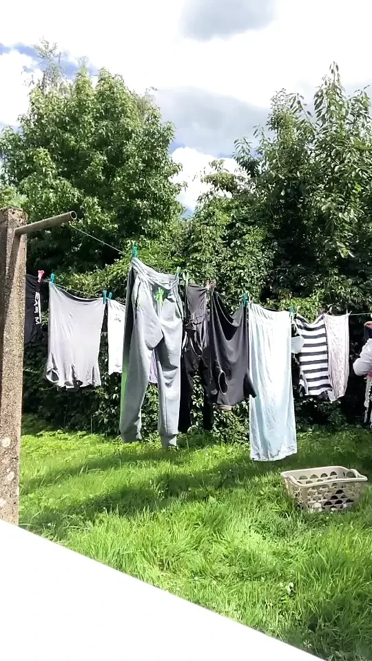In gardening outfit to hang the laundry