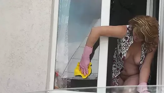 MILF in bathrobe without panties and bra washes window of apartment. Nude in public. Naked in public. Big natural tits MILF