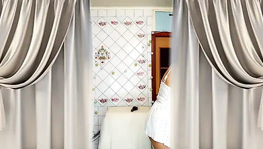 Real home solo of a mature woman in a small cozy kitchen.