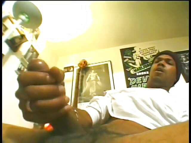 Ghetto thug with wool cap yanks his black tool