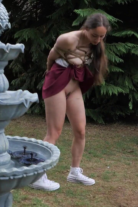 Half-stripped, Bell-jingling Slave Mila Drooling Through Tongue Clamp Is Made to Walk Outdoor Fountain Laps with Crotch Rope Saw