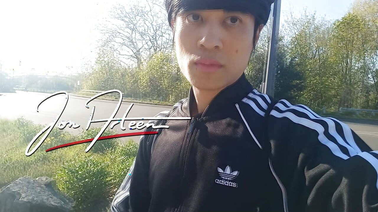 Freeballing public twink walks outdoors commando no underwear beneath black Adidas tracksuit Campus sneakers while out cruising