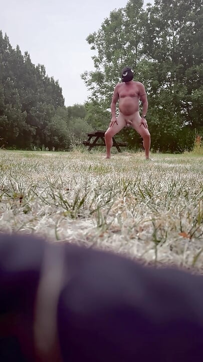 Naked in park standing on benches naked vehicles pass close