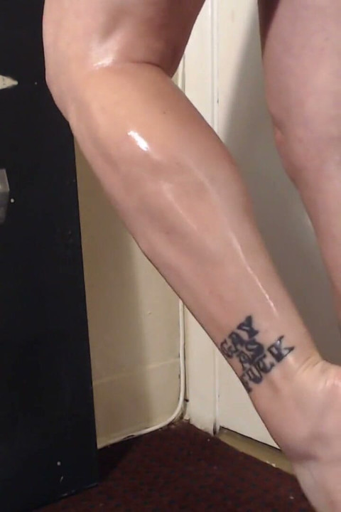Oiled calves flexing calve muscle