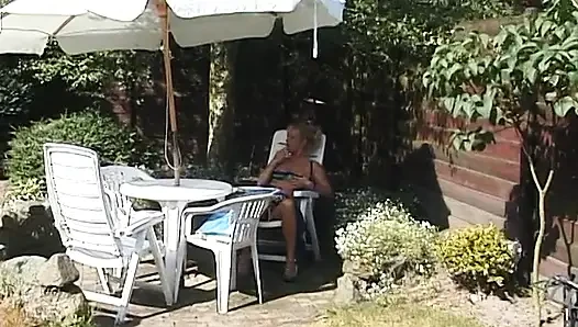 Blonde milf showing off her boobs outdoors