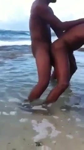 Two black men having sex in the sea