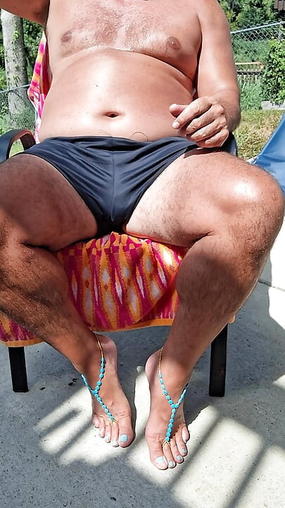 Sitting in my back yard getting a tan while showing off my cock and Gf's barefoot sandals