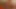 Smoking chick in red satin lingerie warms herself up on couch with dildo