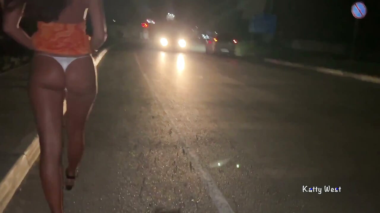 Uma puta caminha pela rua e mostra a buceta para os transeuntes