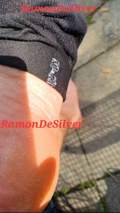 Master Ramon takes off his sweaty shoes and socks and walks barefoot through the damp grass