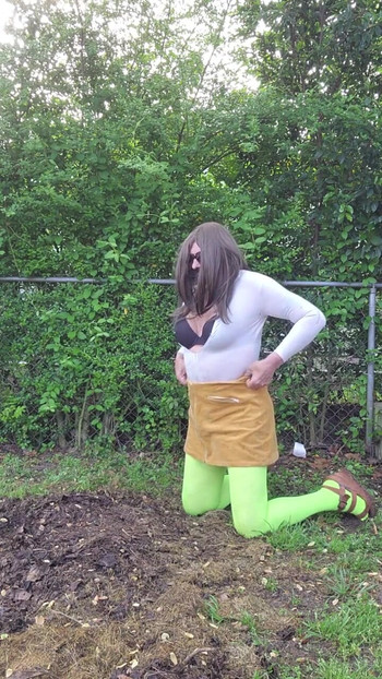 Stunning moment from "Gay crossdress tease, outdoors ground humping in pantyhose, black bra, miniskirt."