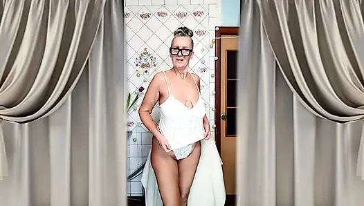 Hot mature housewife Lukerya undresses and teases with her huge tits in the kitchen