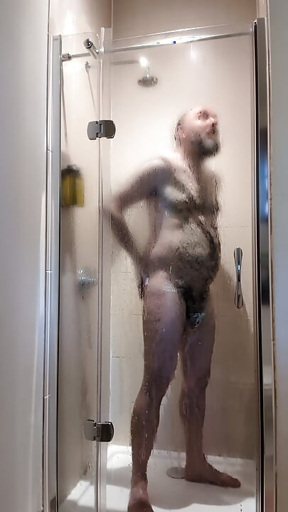 Chastity locked bear takes a ahower