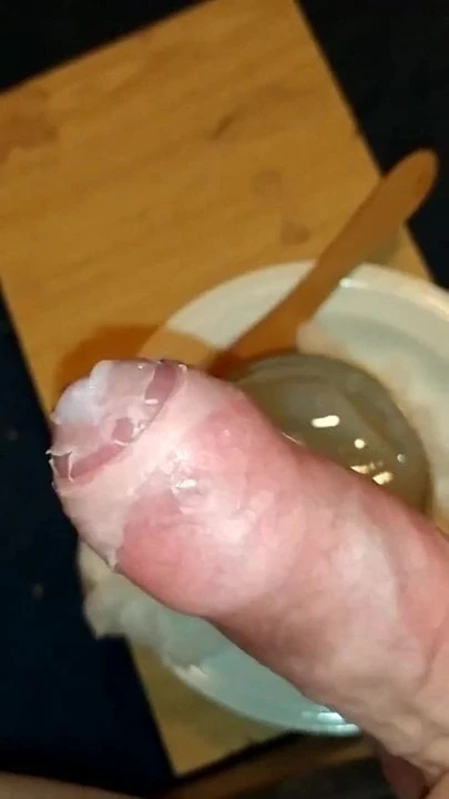 Dipping cock into hot wax