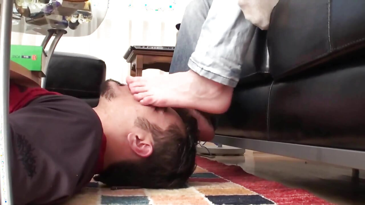 Slave licks their feet from below