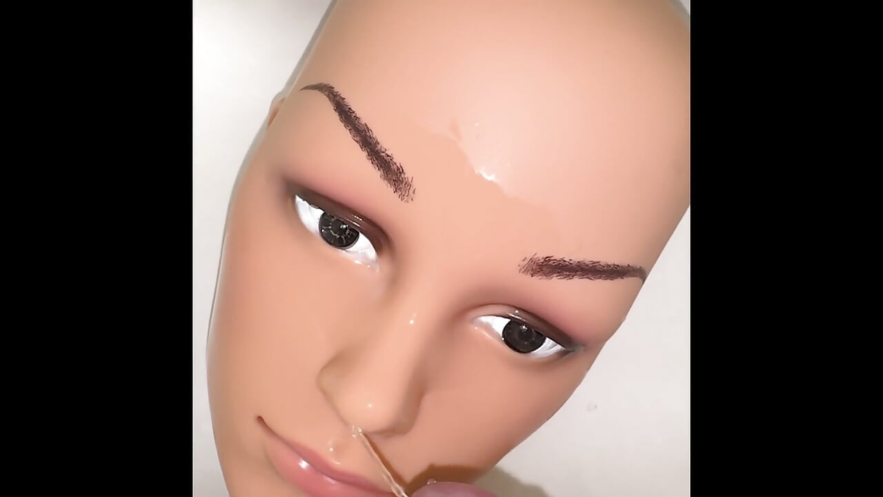 Pissing on a mannequin doll's face