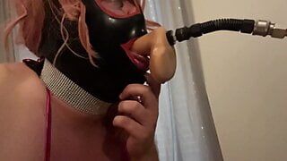 Sissy gagged on a huge dildo while licking the balls