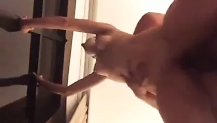 Amateur couple fucking in front of window