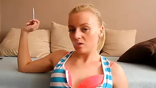 Blonde sweetie smoking a cigarette in close up video