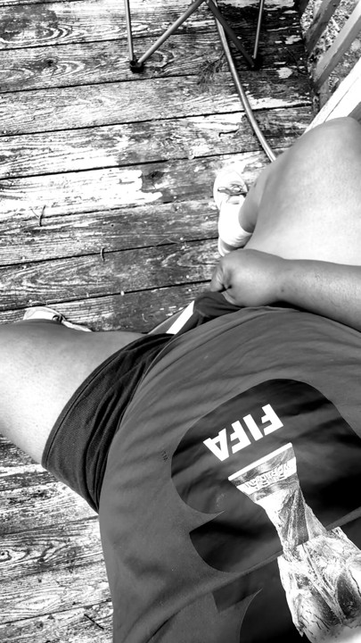 Jerking of on the deck in black and white.