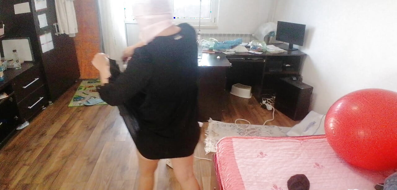Amateur woman has fun trying on clothes and cutting them.