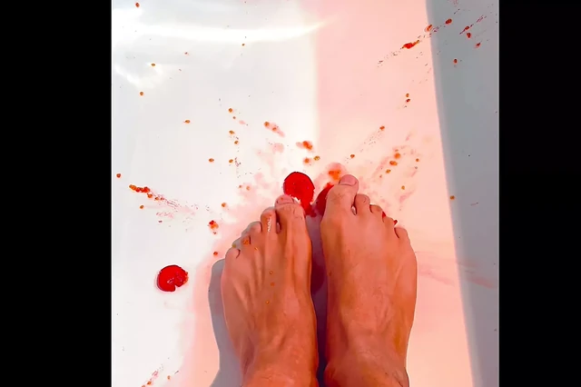 Perfect sexy brown feet squish tomatoes in bathtub