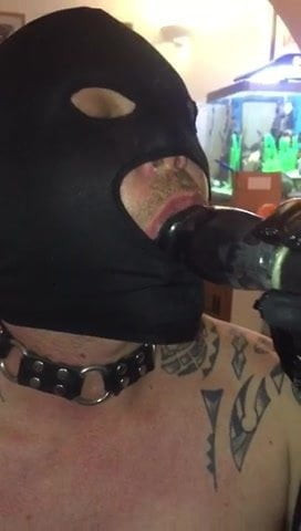 Slave sucks dildo