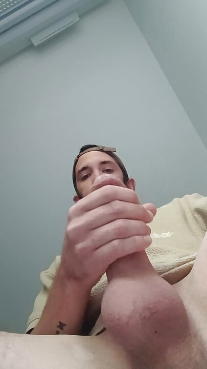 Young guy jerks off his big cock and cums