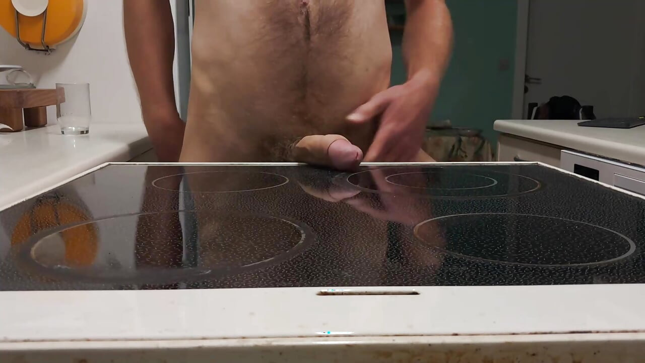 Playing with my cock and cumming on the stove.