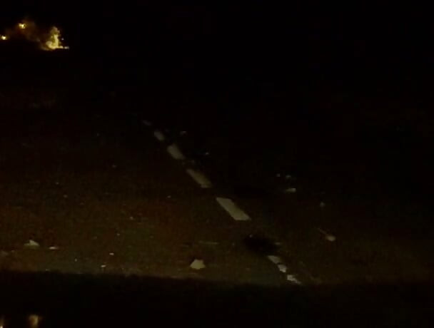 Naked in road and hiding the wrong side of road from safety when car passed