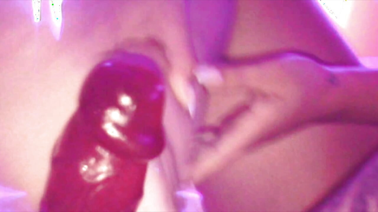 Young Girl Using Her Feet to Play with the Dildo While Masturbating