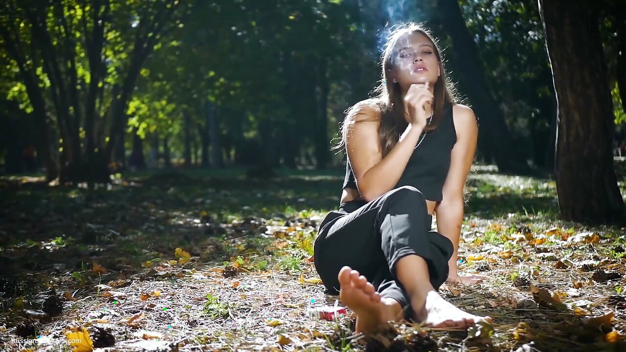 Seductive Russian Beauty Smoking Cigarette in Studio